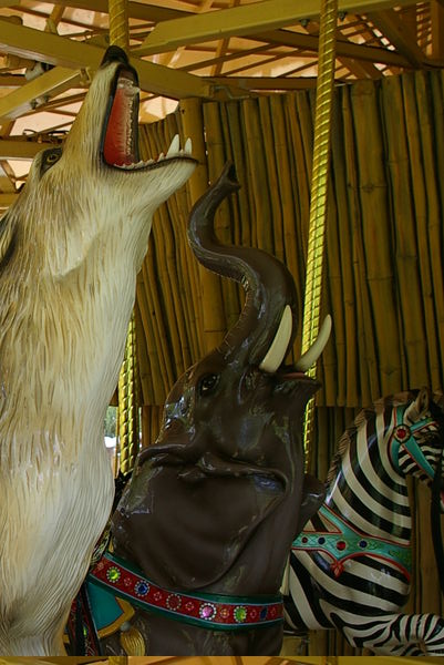 Carousel howling wolf and trumpeting elephant