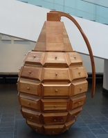 Wooden chest of drawers that looks like a giant hand grenade